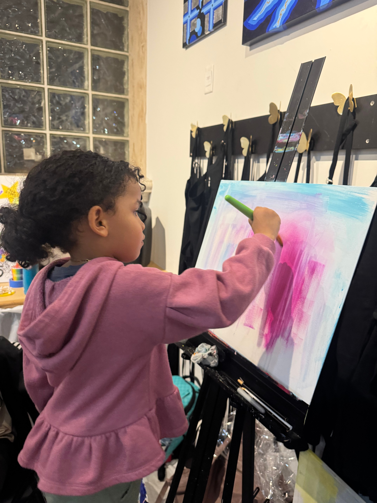 Amillie painting pink and blue strokes