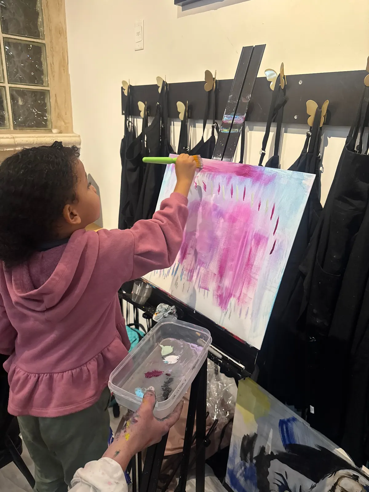 Amillie focused on her canvas